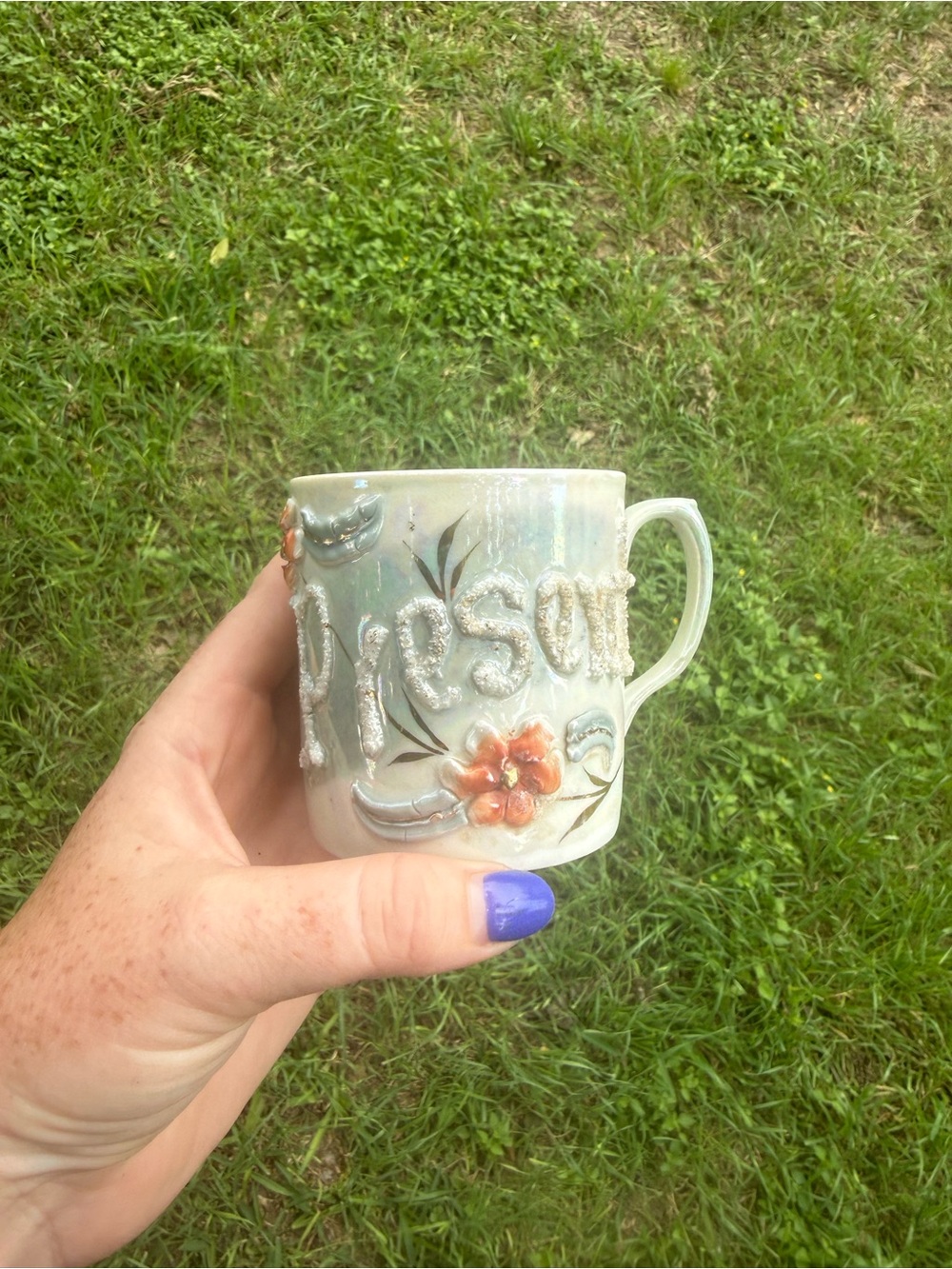 Antique iridescent cream ceramic mug with orange floral relief